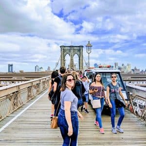 Denise walking across the Brooklyn Bridge in New York