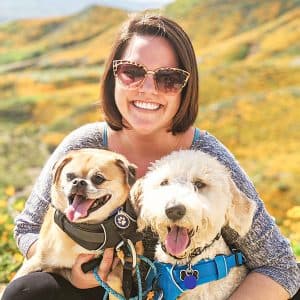 Denise hiking with her two dogs through a wildflower superbloom
