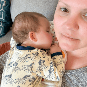 Denise cradling a sleeping baby
