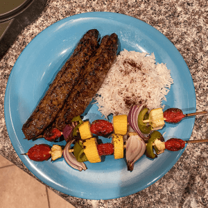 A plate of homemade kebabs and rice